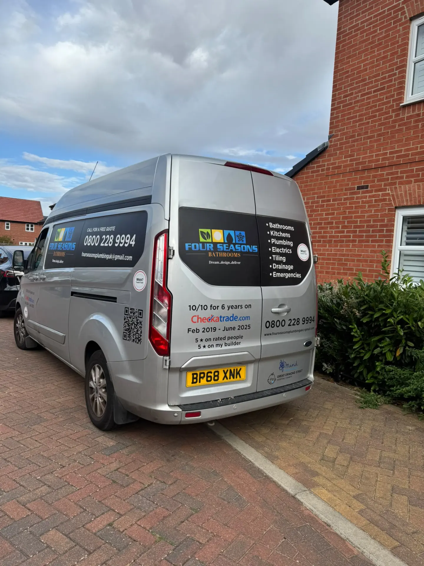 Rear of the Four Seasons Bathrooms van listing bathrooms, kitchens, plumbing, electrics, tiling and drainage services